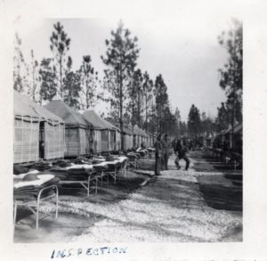 Bunks out in front of tents at Camp Livingston, Louisiana